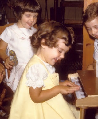 Joan age 3 with piano circa 1968